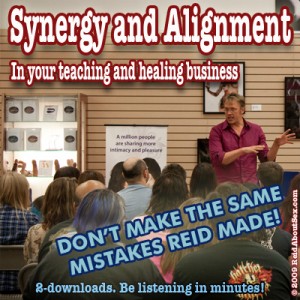 Sex and relationship expert Reid Mihako teaching in front of a large audience with the text "Synergy and alignment in your teaching and healing business," "Don't make the same mistates Reid made," "Two downloads. Be listening in minutes!"