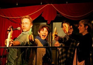 Reid Mihalko and three audience members learning how to deepthroat bananas during Reid's Stand-Up Sex Education show at the SWA fundraiser