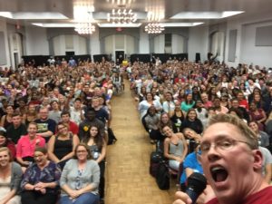 Sex and relationship educator Reid Mihalko of ReidAboutSex.com making a silly face while taking a selfie of the Lynchburg College auditorium's packed house of cheering students before his sexual assault prevention talk entitled "How To Be a Gentleman and Still Get Laid."