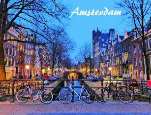 Postcard of Amsterdam featuring bicycles parked against a bridge railing overlooking a canal at dusk