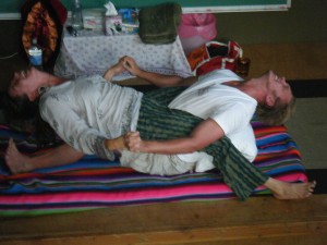 Reid demonstrates the what he calls "Tantric Twitchies"  (Kryias) for the audience with the generous help of Amber Seitz at a  workshop in Oakland