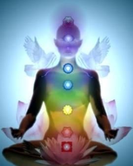 New Age illustration depicting the rainbow colored chakras and "wing-like" auric energy systems of a meditating figure