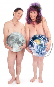 EcoSexuals Elizabeth Stephens and Annie Sprinkle posing nude holding the moon and the earth in front of their private parts against a white background