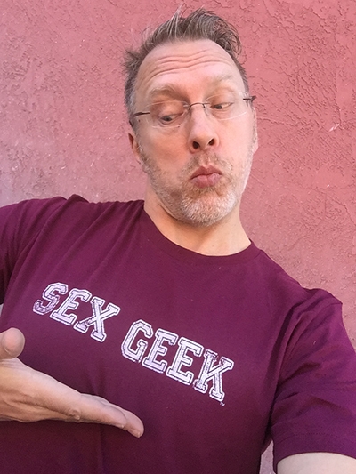 Sex and relationship educator Reid Mihalko sporting a burgundy color Sex Geek thsirt