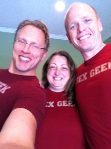 Sex positive educators Reid Mihalko, Cathy Vartuli and Rick Wilkes wearing maroon "Sex Geek" tshirts and smiling at the camera, posing for a group photo