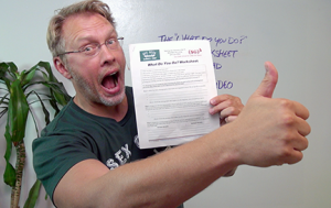 Sex and relationship expert Reid Mihalko of ReidAboutSex.com giving an enthusiastic thumbs up while holding a free worksheet for sex educator on business and marketing