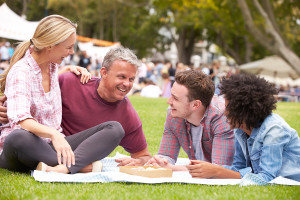 Older Family Relaxing At Outdoor Summer Event