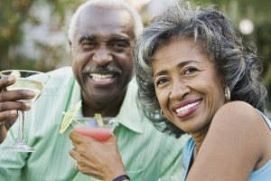 Senior African couple toasting with cocktails