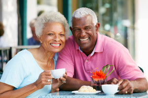 Senior Couple Enjoying Snack At Outdoor Cafe