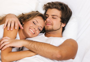 Young beautiful couple sleeping in bed
