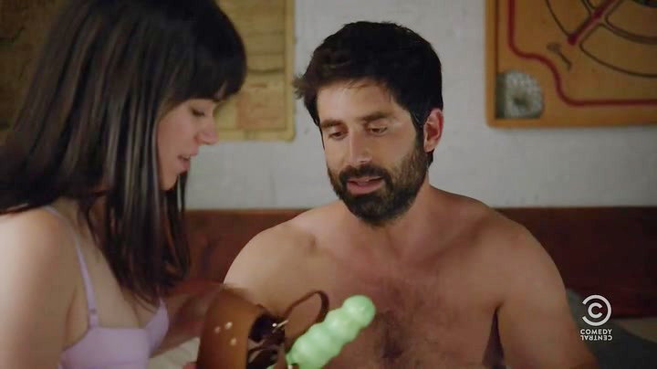 Broad City Season 2, Episode 4 snapshot of Abbi holding Jeremy's strapon harness and green dildo