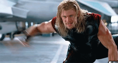Humorous Avengers GIF of Thor reaching out his hand and a red dildo flying into it