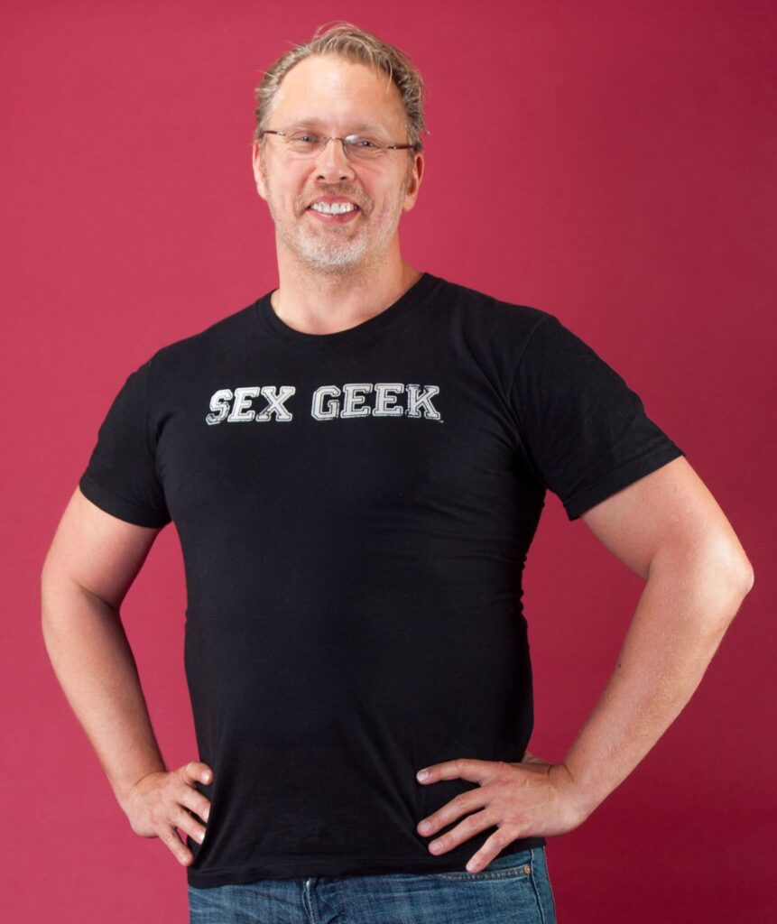 Reid Mihalko in a black, Sex Geek t-shirt