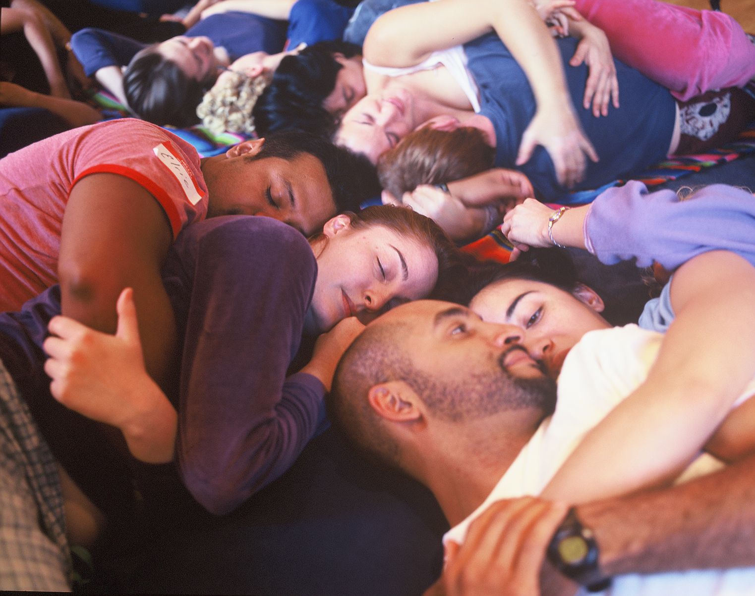 Cuddle Party image of a dozen people cuddling and talking