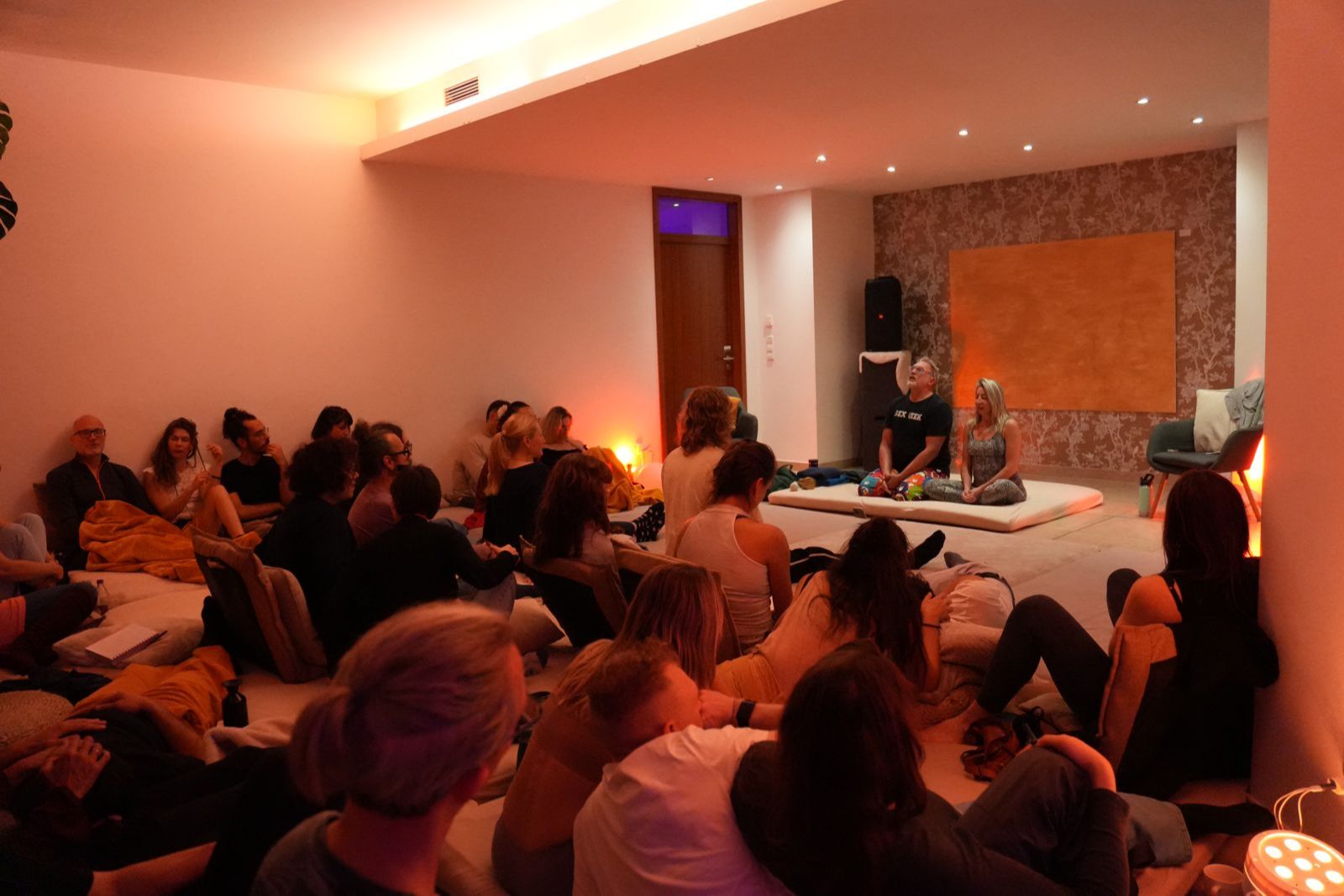 Image of Reid and Rachel laughing and smiling while doing live demonstrations in front of an audience