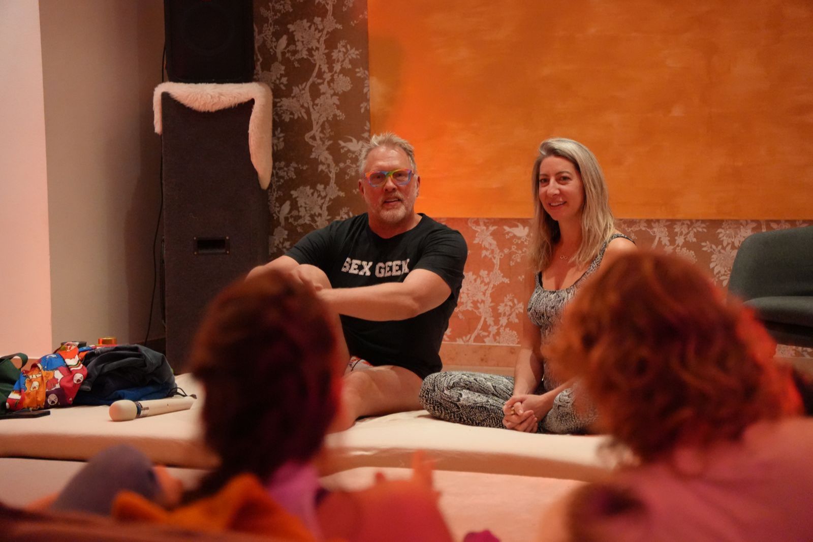 Image of Reid and Rachel laughing and smiling while doing live demonstrations in front of an audience