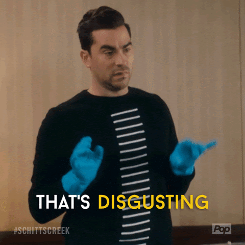 David from Schitt's Creek holding his hands up while wearing blue rubber gloves. Caption reads "That's Disgusting"