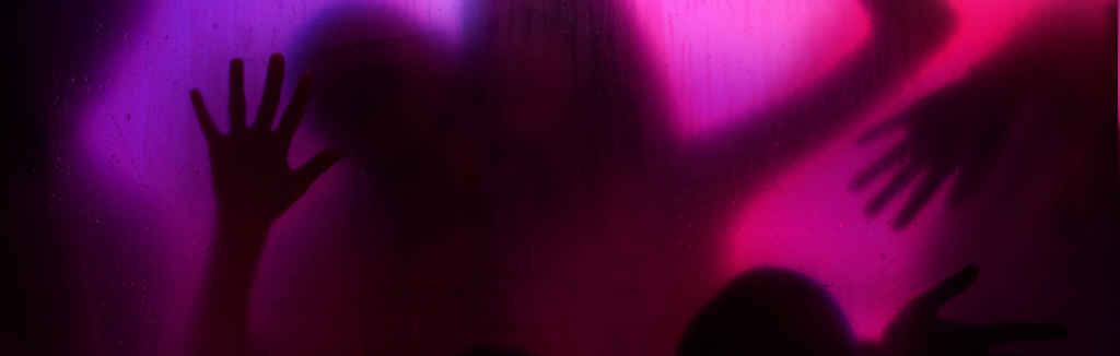 Image of naked people's silhouettes pushed up against each other in sexual positions against wet glass with seductive purple lighting behind them